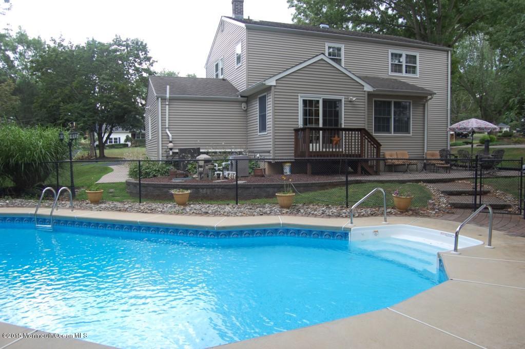 23 Hilltop Road Freehold, NJ 07728 - Photo 6 of 6 a front view of house with yard and trees in the background
