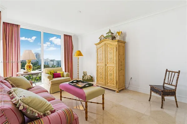 a living room with furniture and a floor to ceiling window