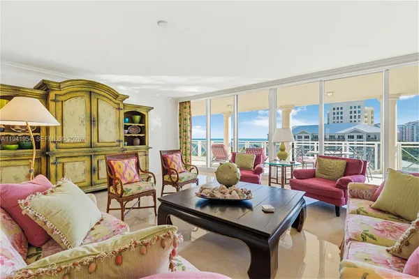 a living room with furniture and a floor to ceiling window