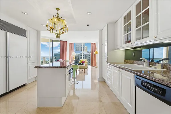 a kitchen with kitchen island granite countertop lots of counter top space and stainless steel appliances