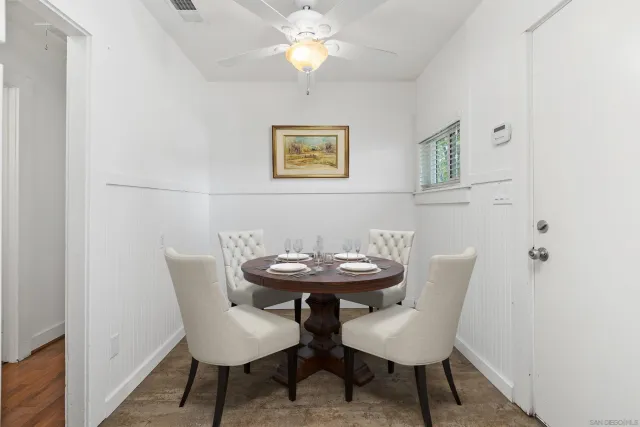 a view of a dining room with furniture and chandelier