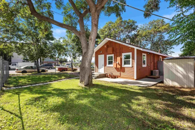 a front view of a house with a yard garage and outdoor seating