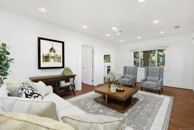 a living room with furniture and wooden floor