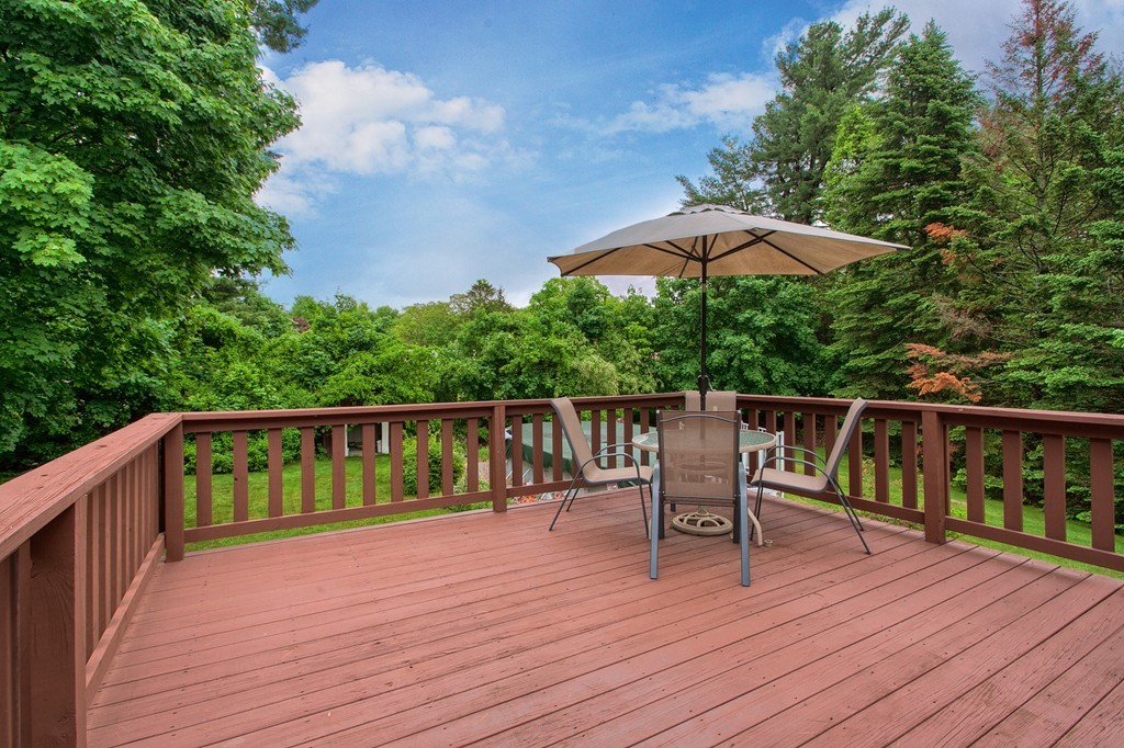 8 Freeman Road Chelmsford, MA 01824 - Photo 3 of 26 a balcony with wooden floor table and chairs