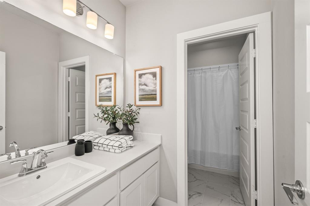 4017 Mapleleaf Pass Melissa, TX 75454 - Photo 26 of 32 a bathroom with a sink and a mirror