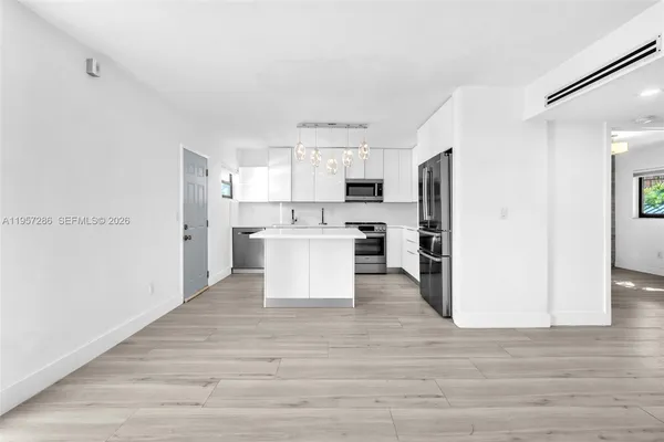 a view of kitchen with wooden floor