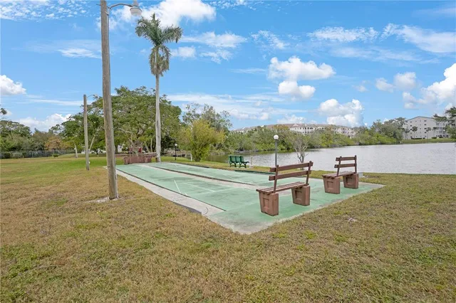 a view of a swimming pool with an outdoor seating and a yard