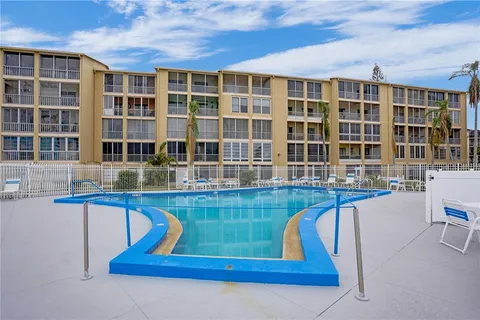 a front view of a house with swimming pool and sitting space