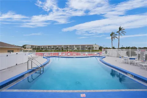 a view of a lake with a table and chairs