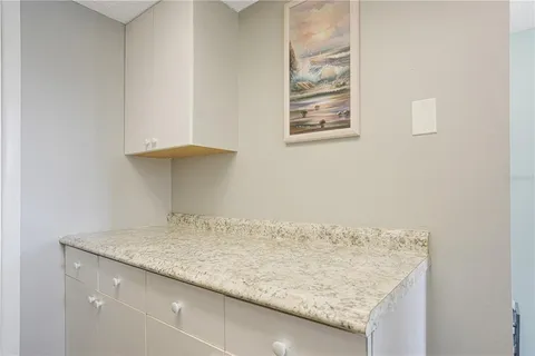 a bathroom with a granite countertop sink and vanity