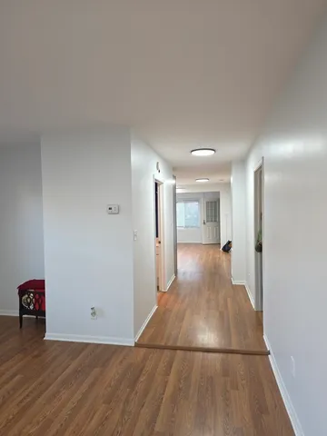 a view of a room with wooden floor