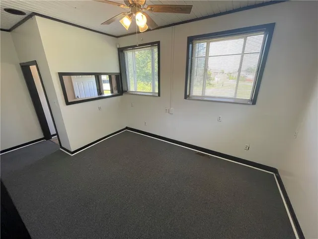 an empty room with windows and painted walls