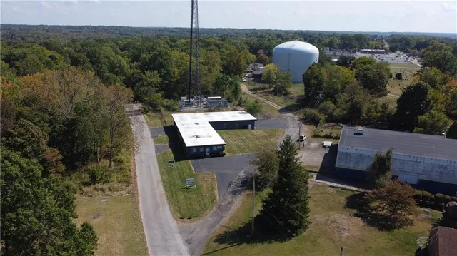 an aerial view of a house with a yard basket ball court and outdoor seating