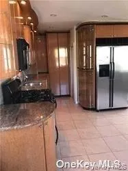a kitchen with refrigerator and window