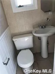 a white toilet sitting next to a bathroom sink