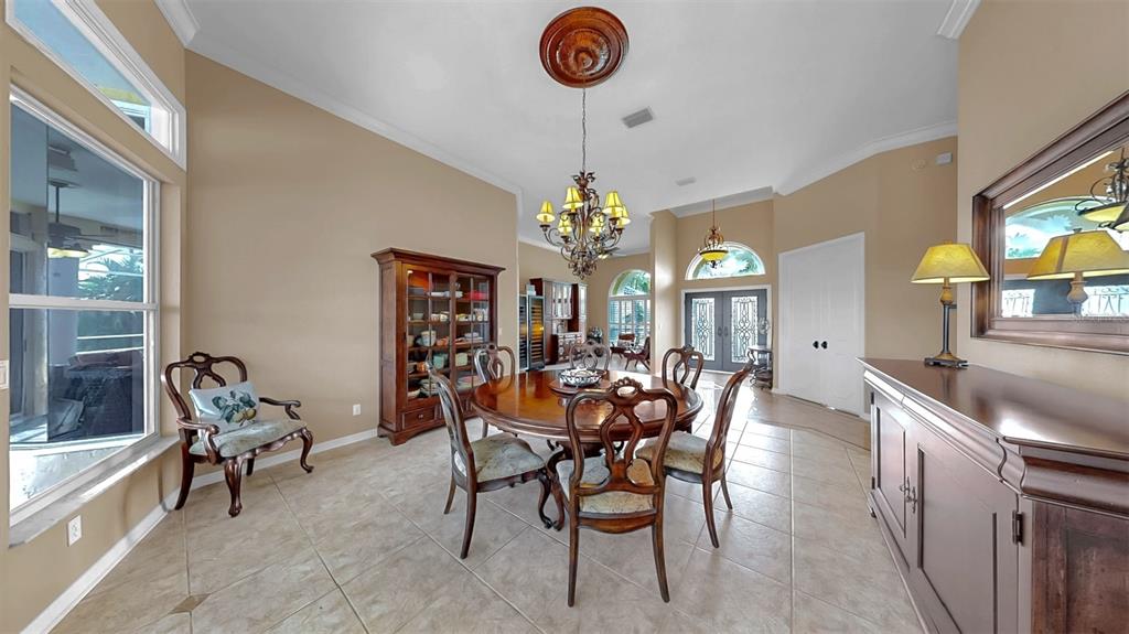 914 Capriccio Lane Apollo Beach, FL 33572 - Photo 12 of 75 a dining room with furniture a chandelier and window