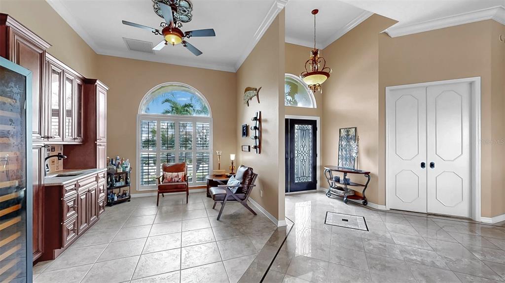 914 Capriccio Lane Apollo Beach, FL 33572 - Photo 14 of 75 a living room with furniture a fireplace and a chandelier