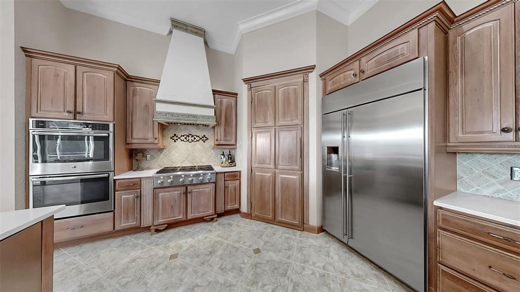 914 Capriccio Lane Apollo Beach, FL 33572 - Photo 20 of 75 a kitchen with stainless steel appliances granite countertop a refrigerator and a stove