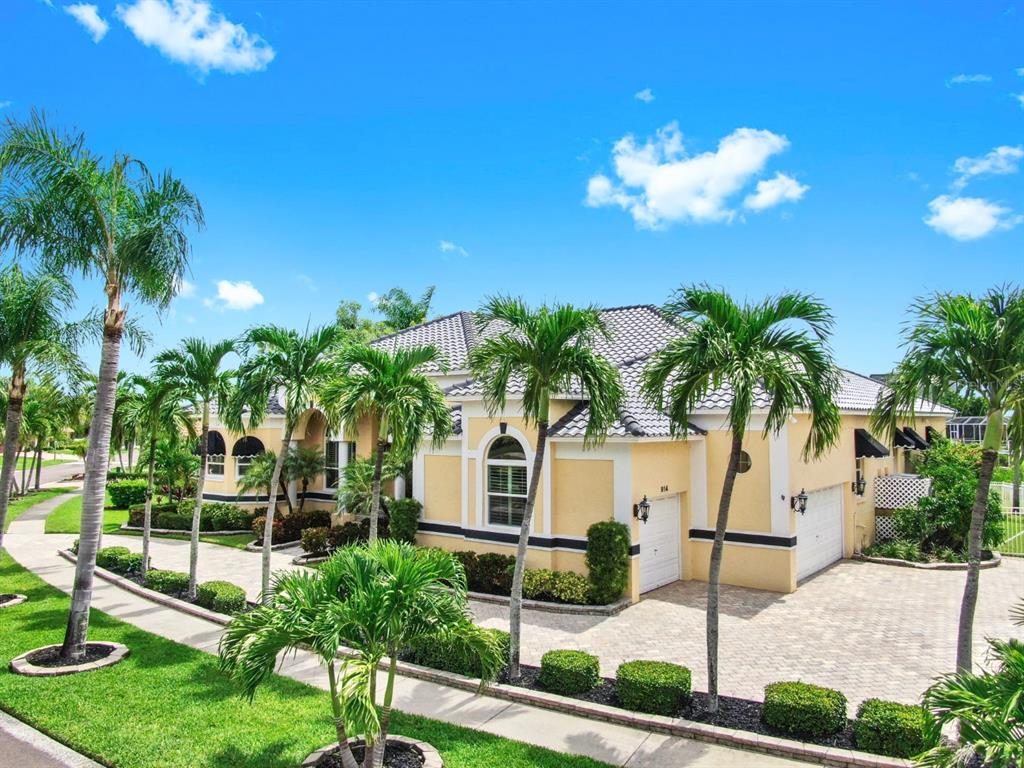 914 Capriccio Lane Apollo Beach, FL 33572 - Photo 2 of 75 a view of a house with a yard and palm trees