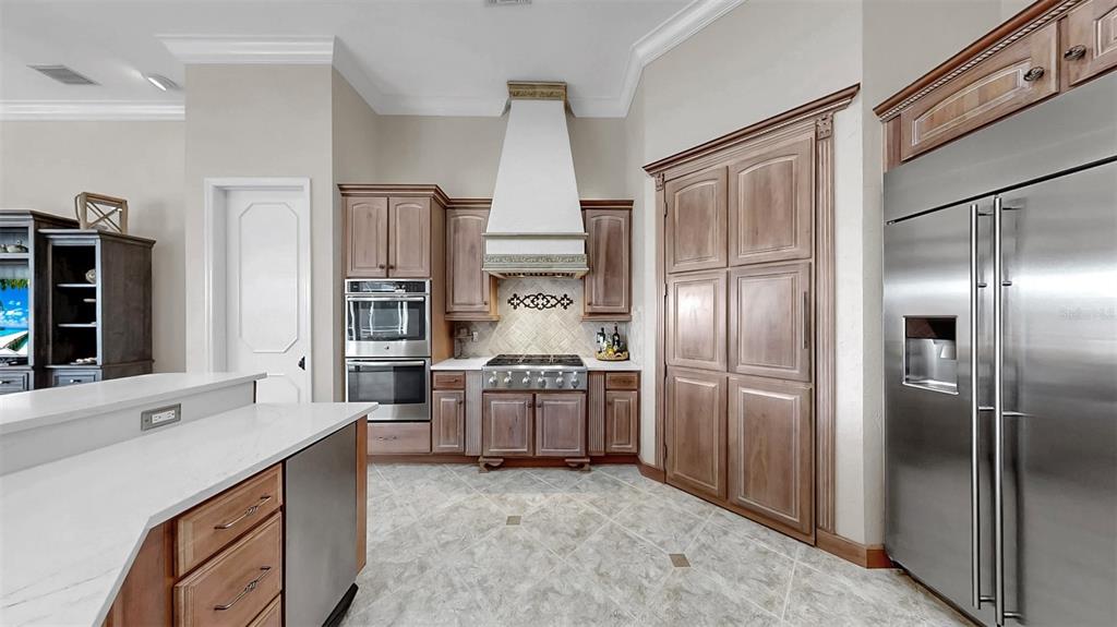 914 Capriccio Lane Apollo Beach, FL 33572 - Photo 22 of 75 a kitchen with stainless steel appliances granite countertop a refrigerator and a stove top oven