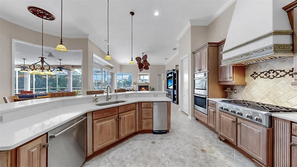 914 Capriccio Lane Apollo Beach, FL 33572 - Photo 23 of 75 a kitchen with stainless steel appliances a stove a sink a center island and windows