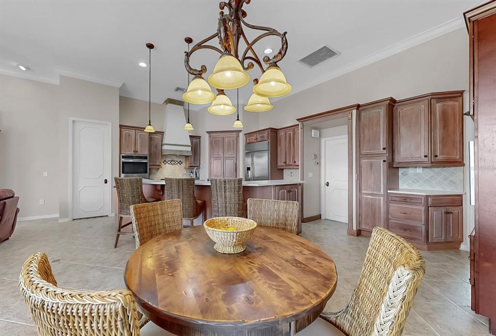 914 Capriccio Lane Apollo Beach, FL 33572 - Photo 26 of 75 a living room with dining table and chairs