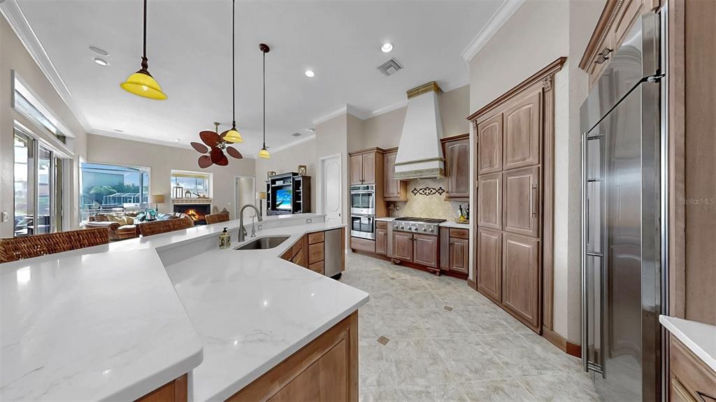 914 Capriccio Lane Apollo Beach, FL 33572 - Photo 31 of 75 a kitchen with stainless steel appliances granite countertop a sink a stove and a refrigerator