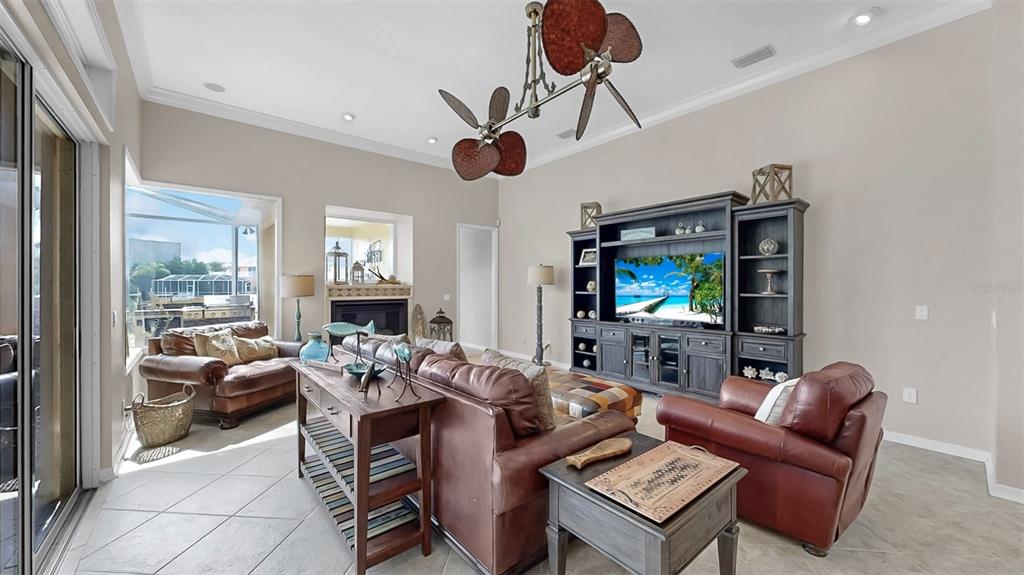 914 Capriccio Lane Apollo Beach, FL 33572 - Photo 36 of 75 a living room with furniture a ceiling fan and a flat screen tv
