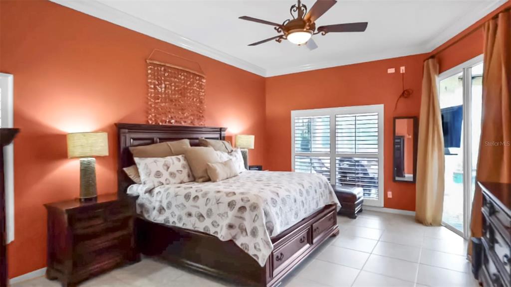 914 Capriccio Lane Apollo Beach, FL 33572 - Photo 39 of 75 a bedroom with a bed and window