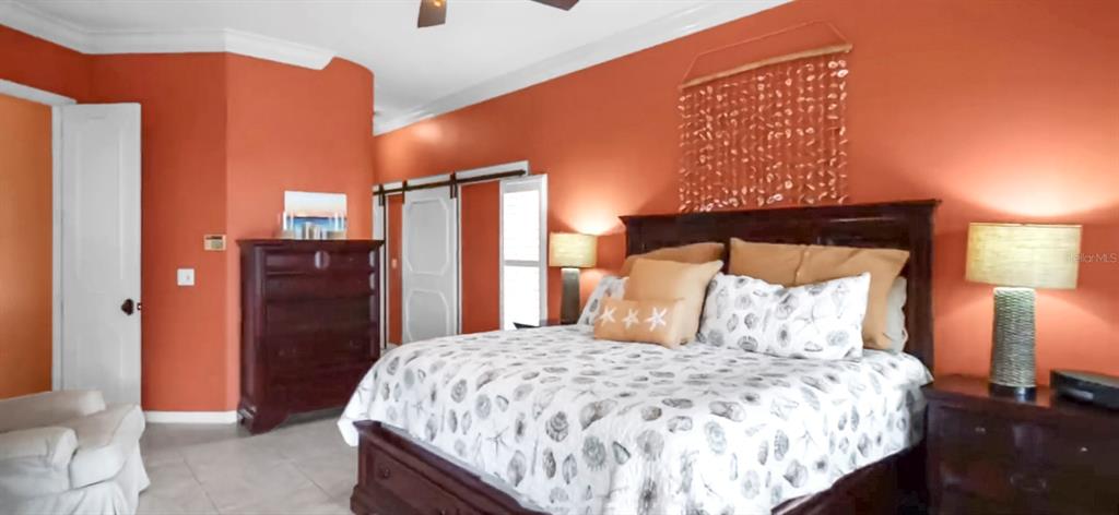 914 Capriccio Lane Apollo Beach, FL 33572 - Photo 40 of 75 a bedroom with a bed and wooden floor