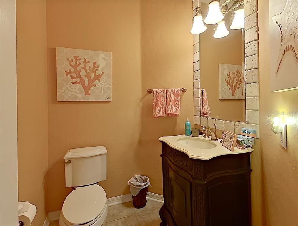 914 Capriccio Lane Apollo Beach, FL 33572 - Photo 49 of 75 a bathroom with a toilet sink and mirror