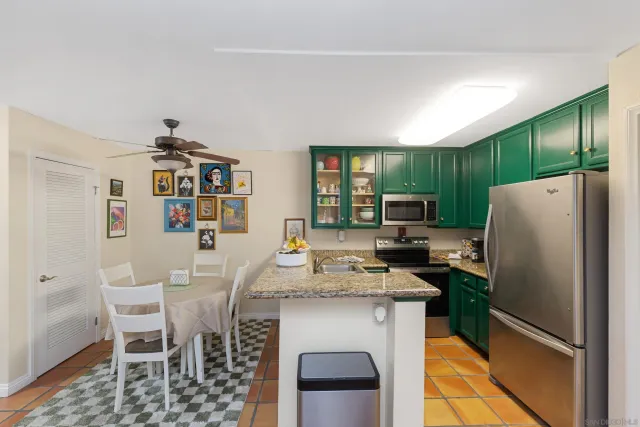 a kitchen with stainless steel appliances a refrigerator stove microwave and cabinets