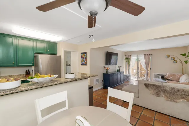 a living room with stainless steel appliances granite countertop furniture a couch and a view of living room