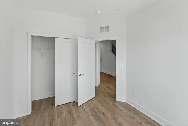 a view of hallway with wooden floor