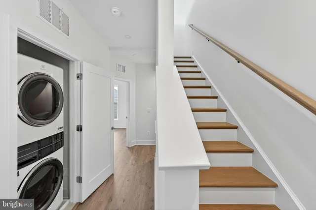a view of a hallway with washer and dryer