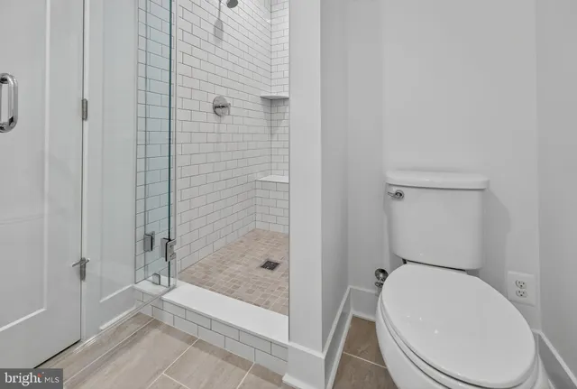 a bathroom with a toilet and shower