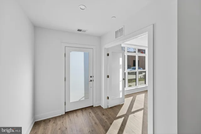 a view of front door with wooden floor
