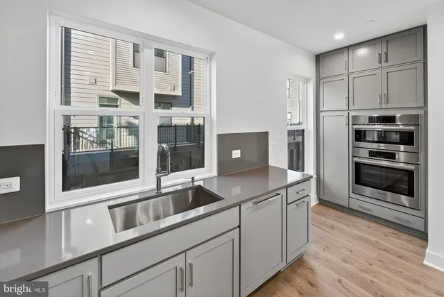 a kitchen with stainless steel appliances granite countertop a stove and a refrigerator
