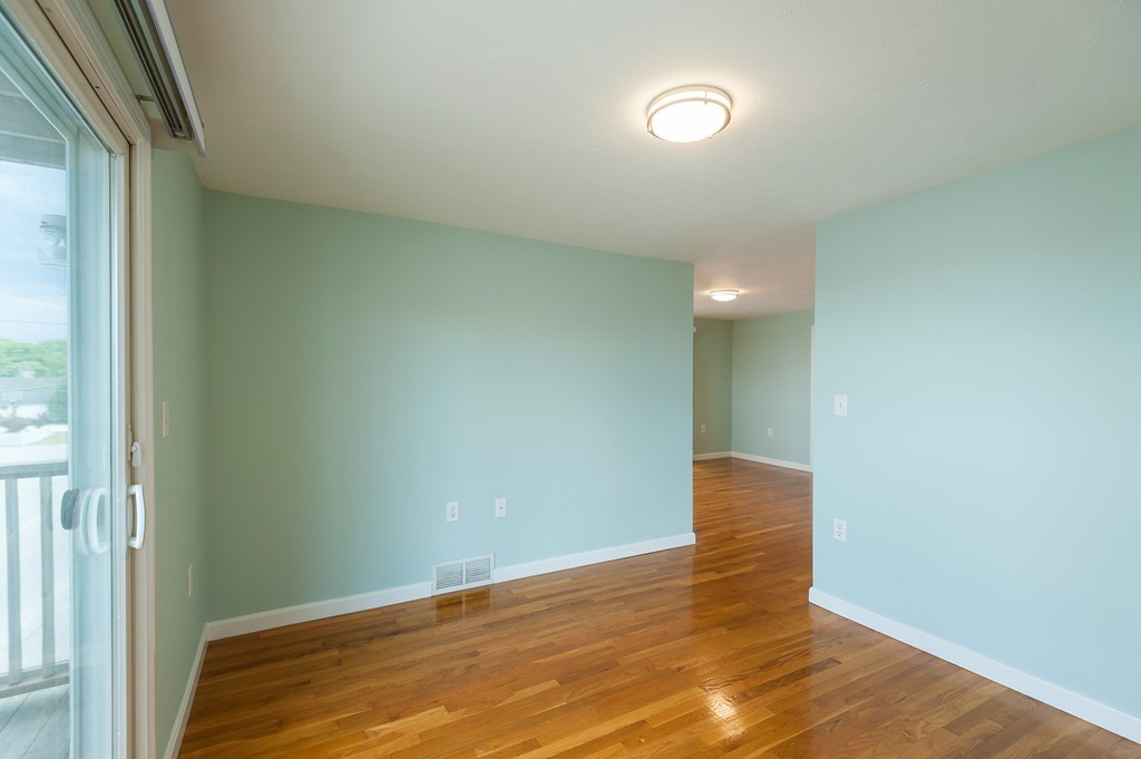 149 Jericho Road, Unit B Scituate, MA 02066 - Photo 12 of 22 a view of an empty room with wooden floor and a window