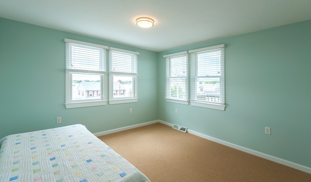 149 Jericho Road, Unit B Scituate, MA 02066 - Photo 18 of 22 a bedroom with a bed and a window