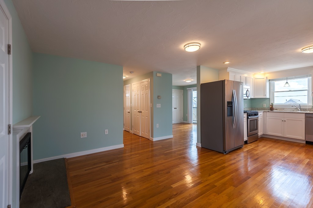 149 Jericho Road, Unit B Scituate, MA 02066 - Photo 8 of 22 a view of a kitchen with wooden floor and electronic appliances