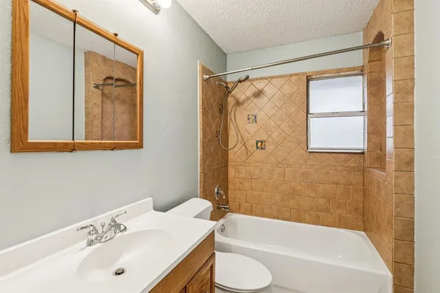 a bathroom with a sink and a bathtub with shower