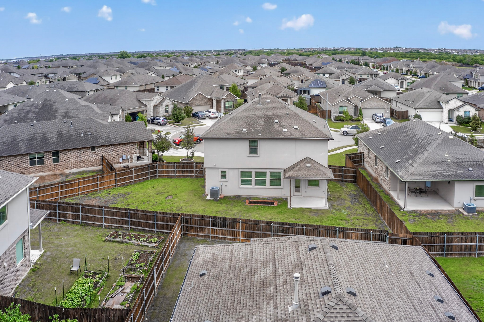 16809 Guido Cove Pflugerville, TX 78660 - Photo 36 of 40 Spacious backyard featuring a privacy fence, covered patio, and manicured lawn