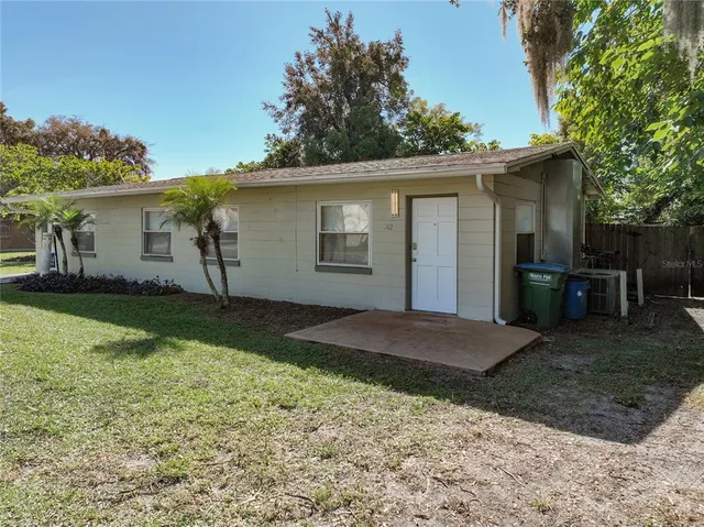 a view of a yard with a house and a tree