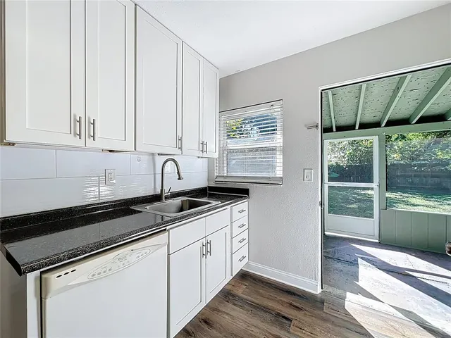 a view of a kitchen with sink and window