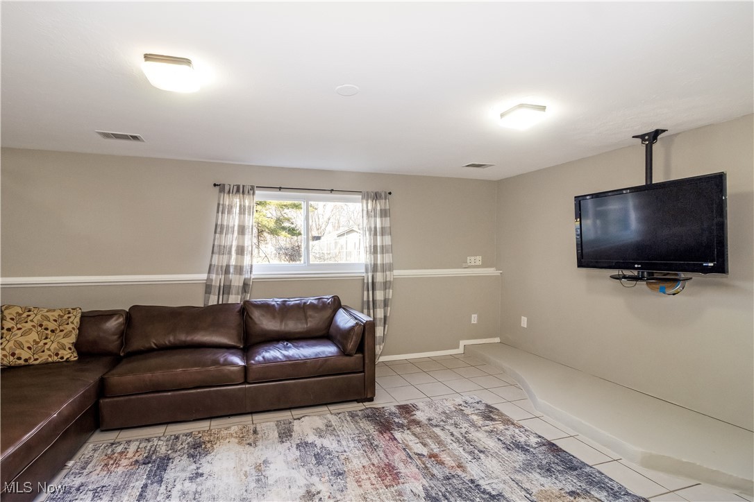 5900 Lear Nagle Road North Ridgeville, OH 44039 - Photo 21 of 35 Living room with tile patterned floors, visible vents, and baseboards
