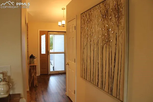 a view of a hallway with wooden floor