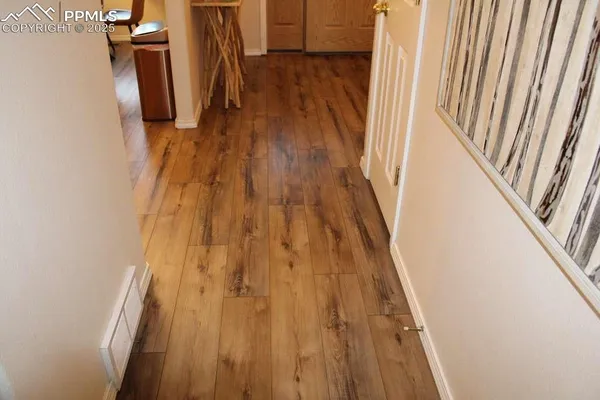 a view of a closet and wooden floor