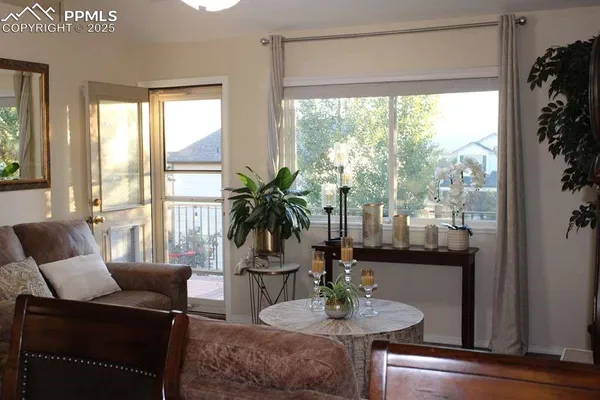 a living room with furniture and a potted plant
