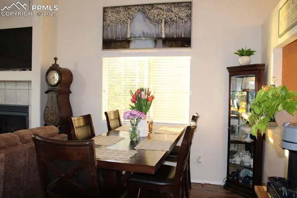 a view of a dining room with furniture and wooden floor